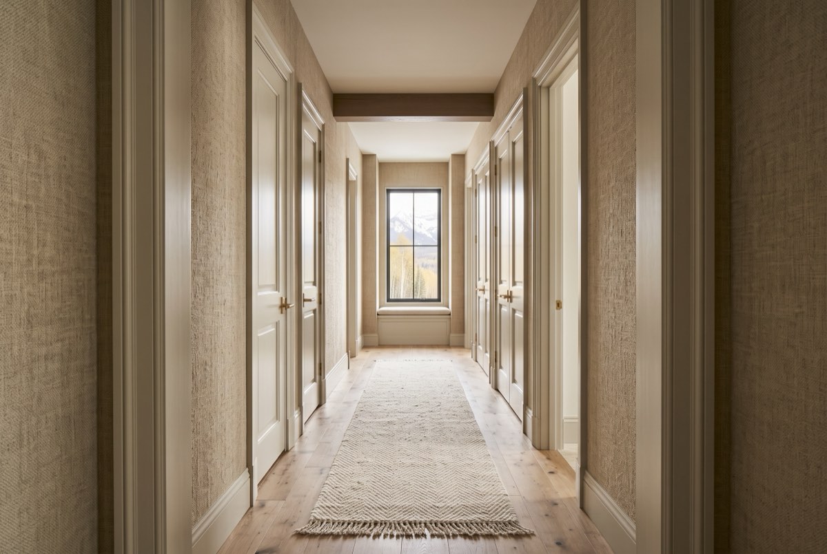 Oatmeal bouclé textile wallcovering along a hallway with paneled doors, Deer Valley, Utah