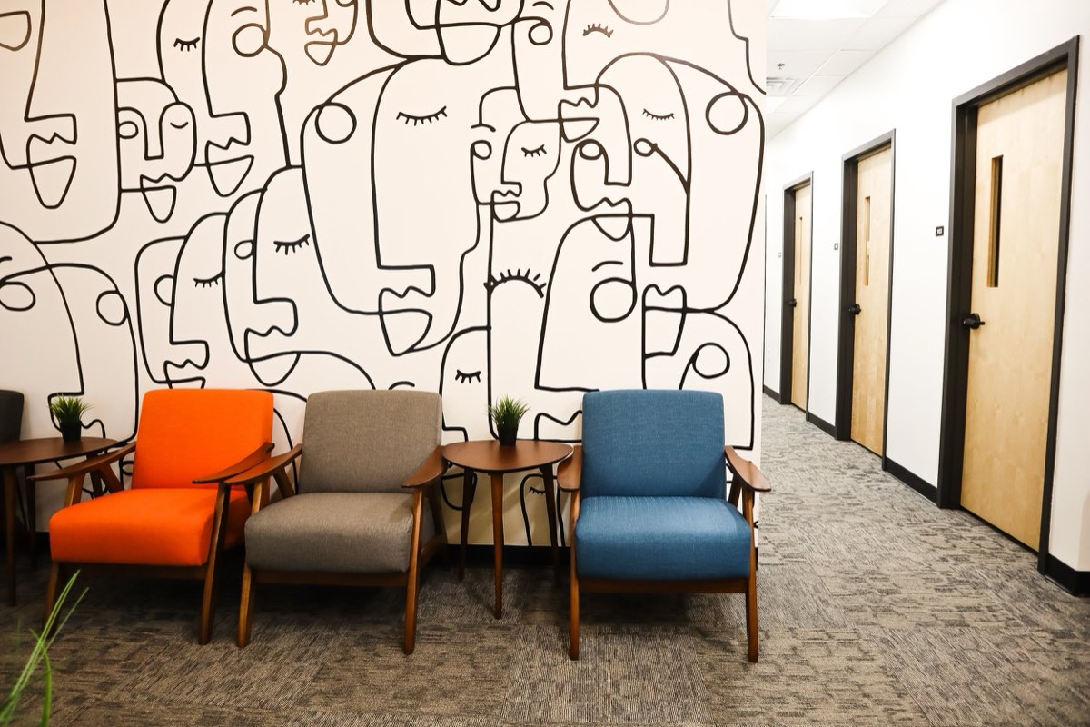 Abstract line-art contract wallcovering in a corporate office waiting area, installed by Mancini Wallpapers