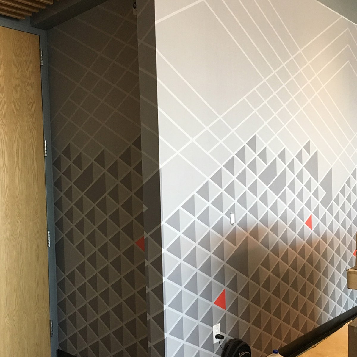Geometric triangle Type II wallcovering, seam detail close-up, commercial installation