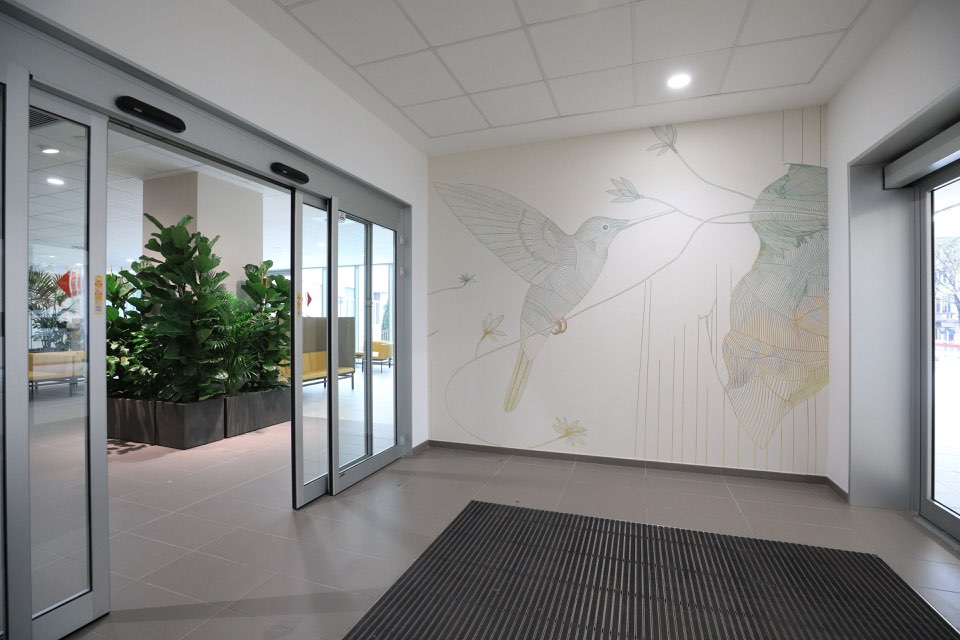Hummingbird mural in a commercial lobby entry, Salt Lake