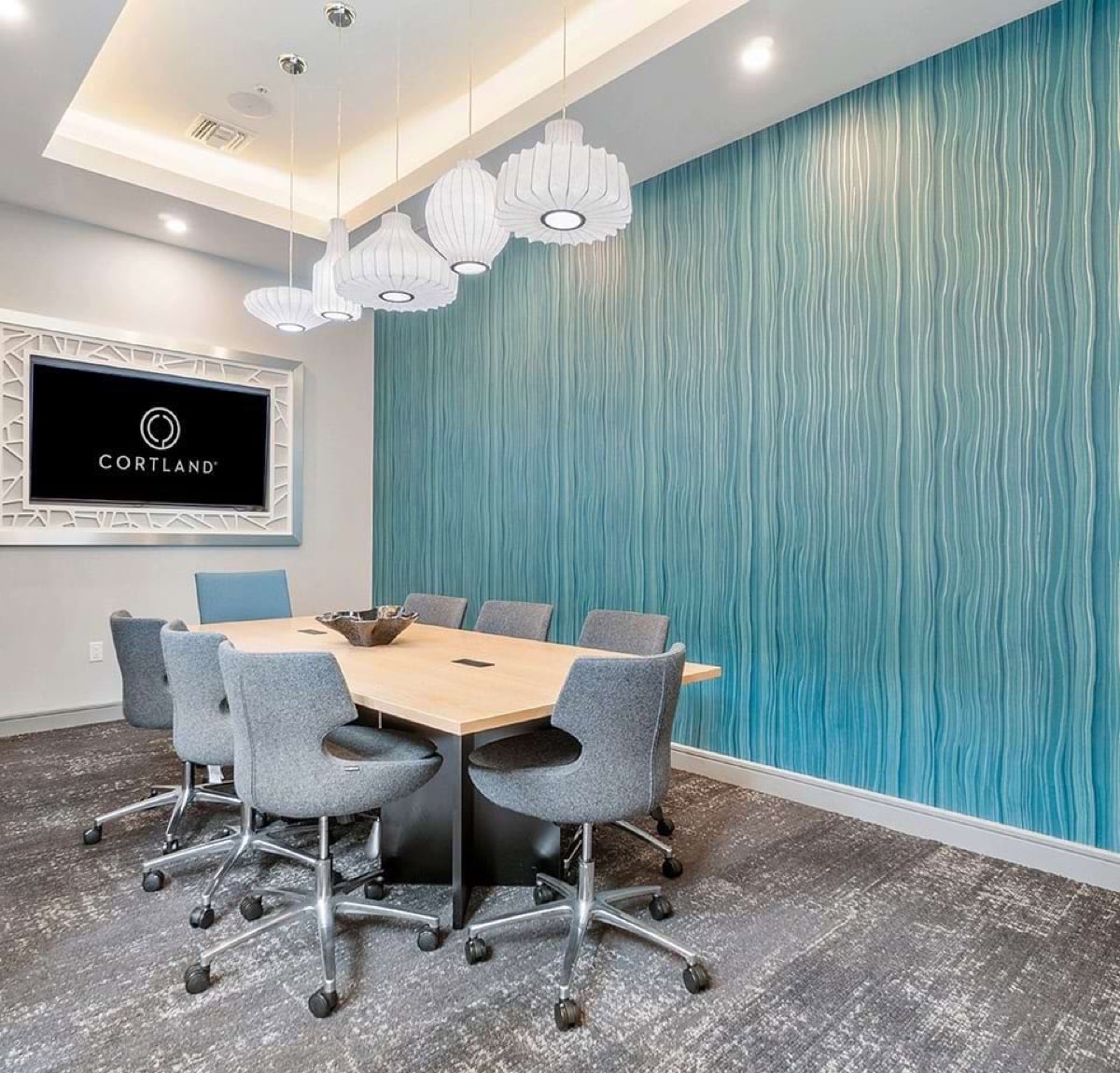Teal wave textured contract wallcovering in a conference room, installed by Mancini Wallpapers