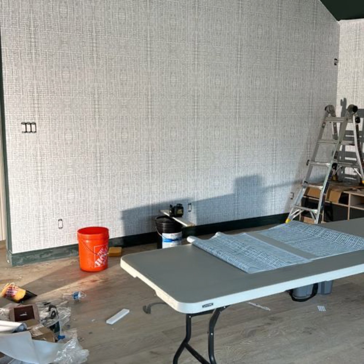 Textured contract wallcovering installation in progress on a commercial site, Mancini Wallpapers