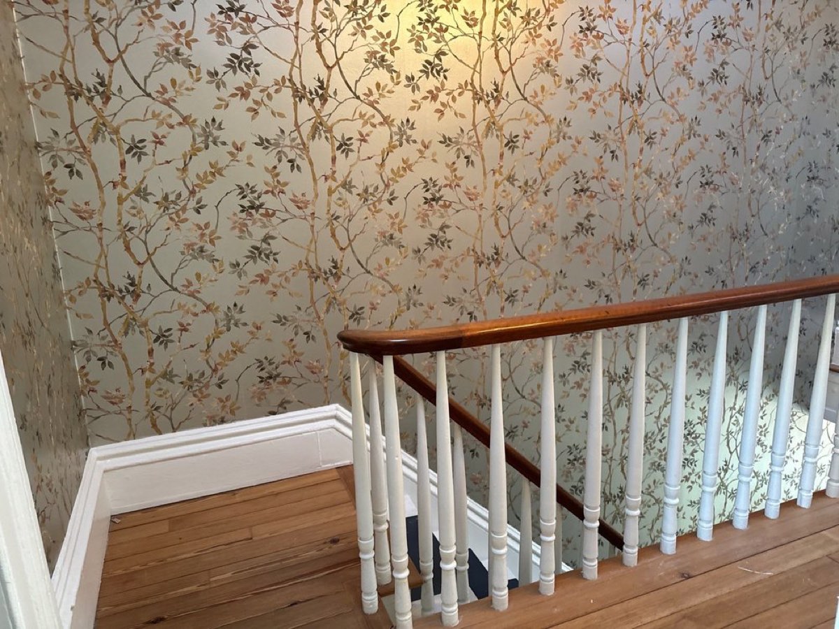 Floral vine wallpaper along a staircase and banister, Utah, installed by Mancini Wallpapers