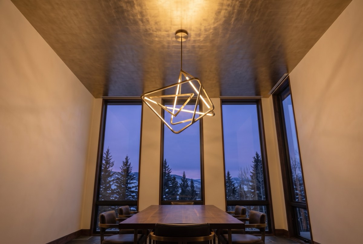 Metallic foil ceiling reflecting a chandelier over a dining room, Park City, Utah