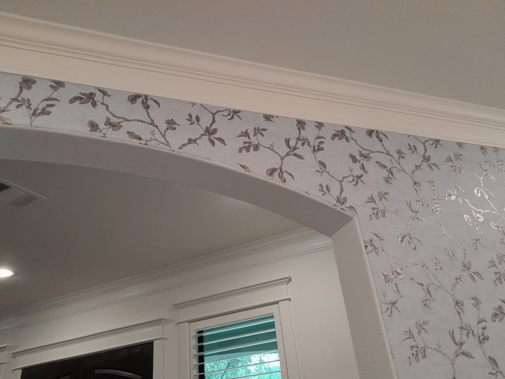 Silver floral vine wallpaper cut cleanly around an arch, detail, installed by Mancini Wallpapers