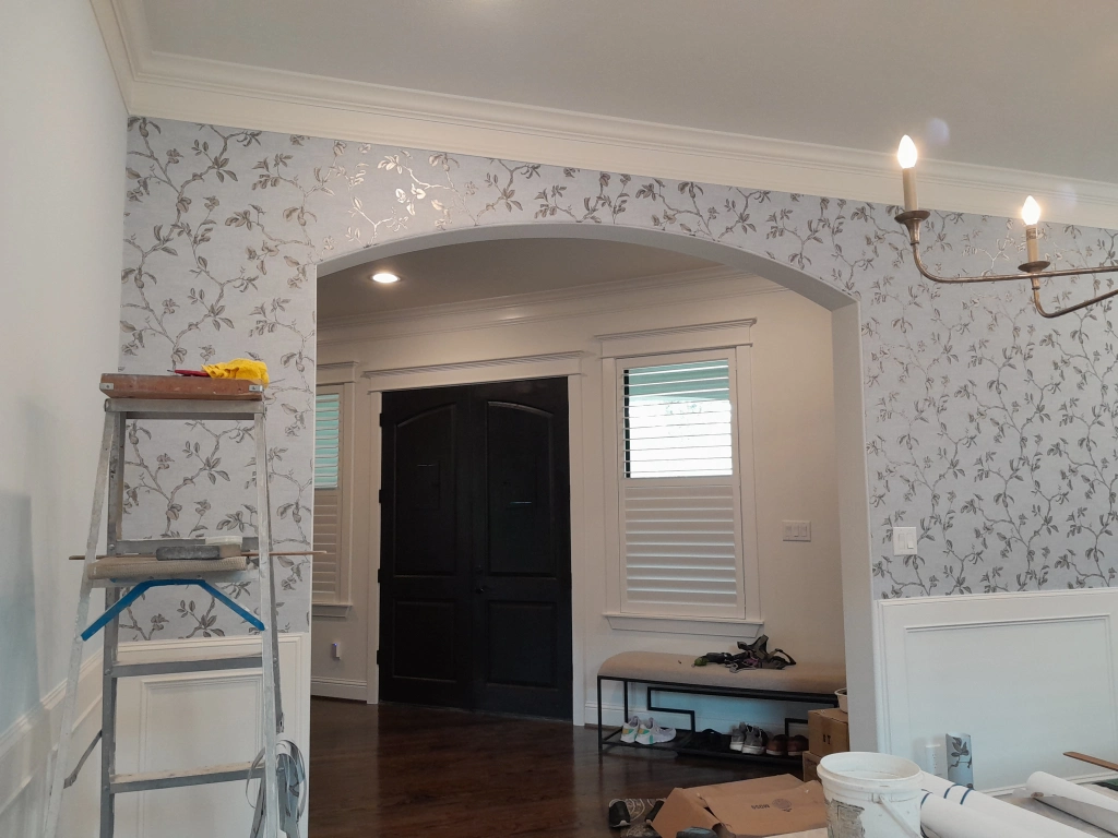 Silver floral metallic wallpaper through an arched entryway, full room, installed by Mancini Wallpapers