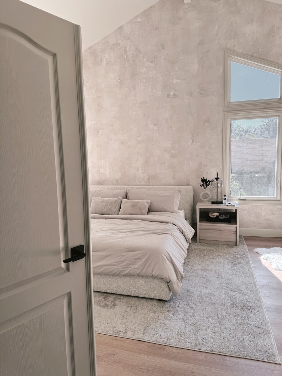 Textured plaster-effect wallpaper across a vaulted bedroom ceiling, installed by Mancini Wallpapers