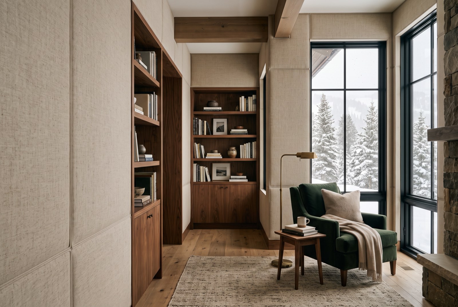 Upholstered oatmeal linen wall panels between walnut shelves in a library, Park City, Utah