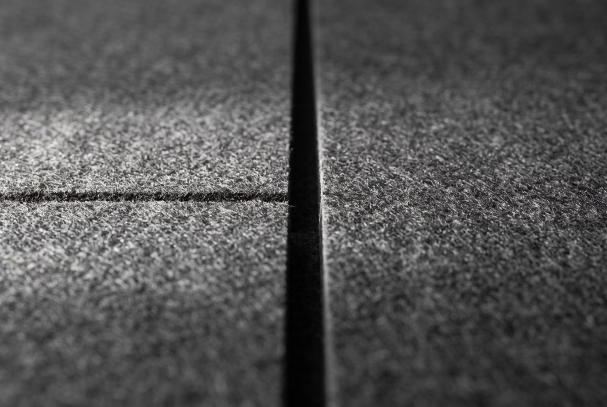 Wool felt panel edge and shadow-gap reveal, cut clean, close detail, Park City, Utah