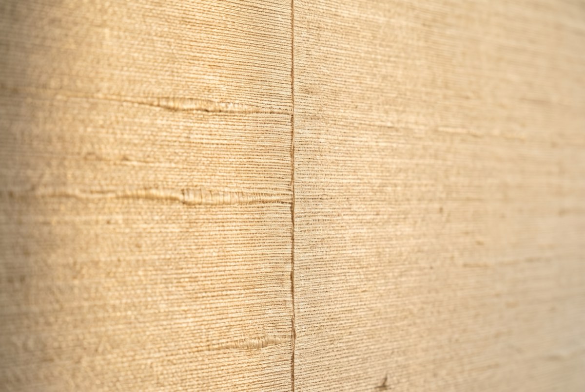 Woven silk wallcovering texture in raking light with a butted seam, Park City, Utah